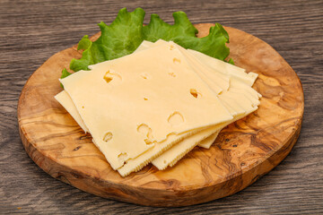 Sliced yellow cheese over board