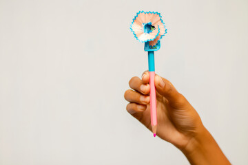 hand holding pencil with sharpener.