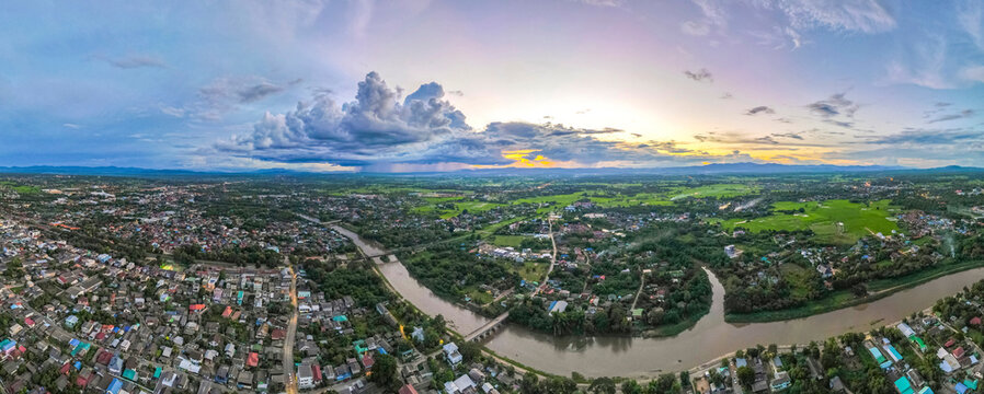 Aerial drone view of Lampang city Thailand, Rainstorm over the mountain background in the sunset