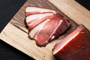 Food concept  Artisan Fresh smoked Bacon on wood cutting board with copy space