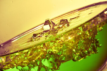 Glass flask. Liquid and crystals. Colored liquid.