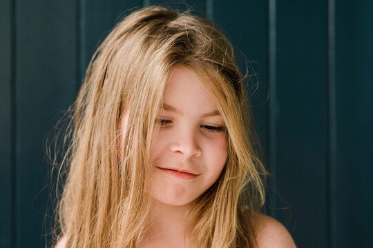 Closeup of a smiling young girl in front of a door outside