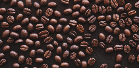Close up of roasted coffee beans on black background 