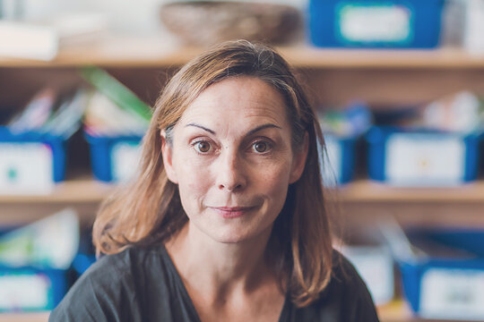 White woman with brown eyes wearing black top looking at camera.