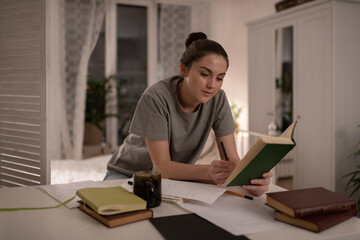 Calm woman preparing for exams at home