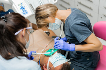 dentistry under general anesthesia. The dentist treats the patient under general anesthesia....