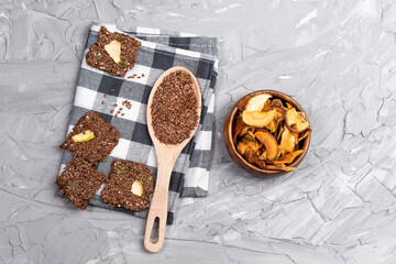 crackers from grain flax seeds, spices, and dried fruit wooden board, healthy food. flat lay