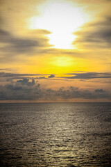 Dramatic sunset sky with clouds.Sunset ocean tranquil scene.Fantastic view of the dark overcast sky. Dramatic and picturesque everning scene.Fiery Backdrop Over Water