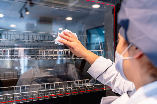 cook in her restaurant cleaning the oven