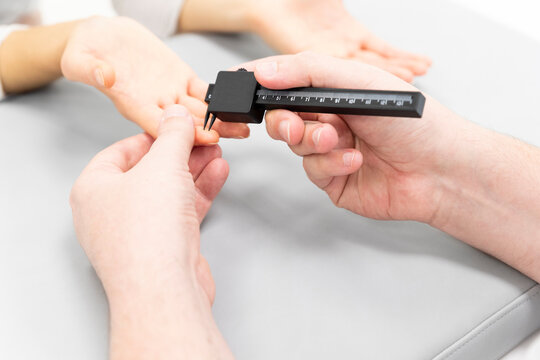 a doctor testing the sensitivity of a patient's finger