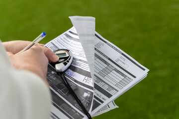 sheet of paper and stopwatch during sports performance analysis