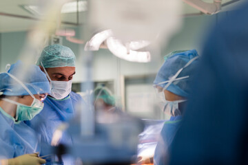 a surgeon in the operating room watching a patient