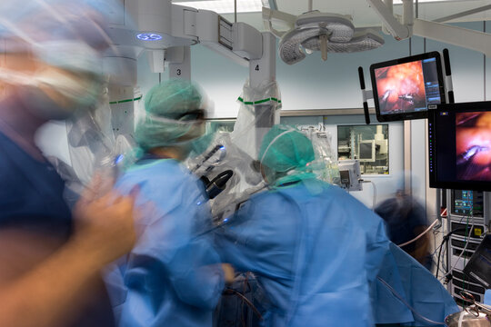a group of surgeons are busy in the operating room
