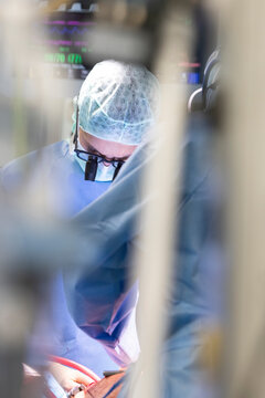 close up view of a heart surgeon wearing his magnifying glasses