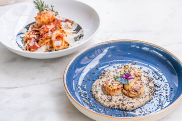 Seared scallop appetizer in dish