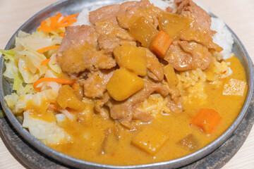 Curry and salad with pork cutlet.