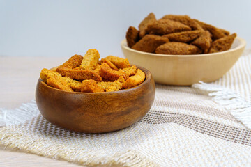 brown crackers croutons in a wooden bowl with space to copy text, no waste