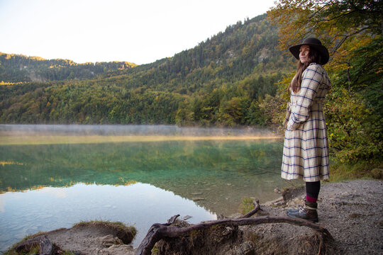 A hipster girl standing by the edge of a lake in Germany