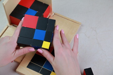 Montessori binomial and trinomial cubes 