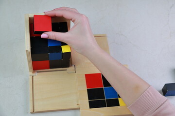 Montessori binomial and trinomial cubes 