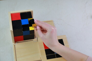 Montessori binomial and trinomial cubes 