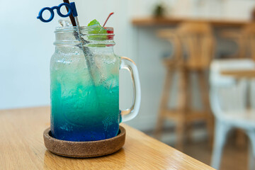 Blue and red sweet drink in glass vintage tank.