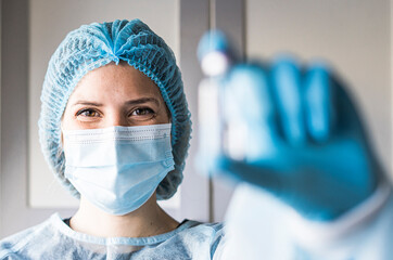 Medical doctor or laborant holding tube with nCoV Coronavirus vaccine for 2019-nCoV virus.