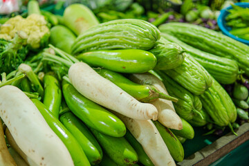 A stall in a market selling assorted vegetables including
