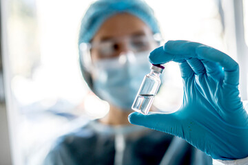 Medical doctor or laborant holding tube with nCoV Coronavirus vaccine for 2019-nCoV virus.