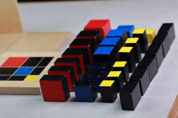 Montessori binomial and trinomial cubes 
