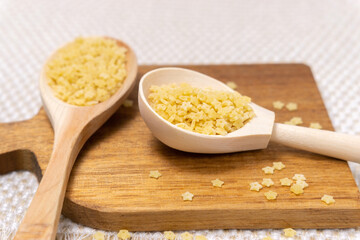 Ingredients for Italian pasta with tiny stelline pasta usually used in soups. close up