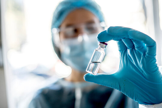 Medical doctor or laborant holding tube with nCoV Coronavirus vaccine for 2019-nCoV virus. - Powered by Adobe