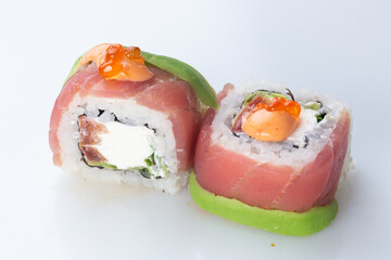 .traditional Japanese cuisine. japanese sushi isolated on white background. maki sushi with salmon, avocado, tomato, soft cheese (Philadelphia) and red caviar.