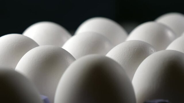The shiney egg shells of the eggs on the tray found inside the room