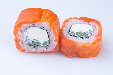 traditional Japanese cuisine. japanese sushi isolated on white background. maki sushi with salmon, cucumber, soft cheese (Philadelphia).