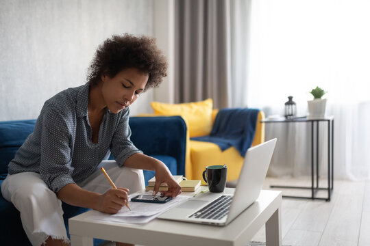 Black woman analyzing finances at home
