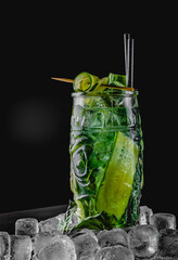 cucumber and mint lemonade in a glass on black wooden table background