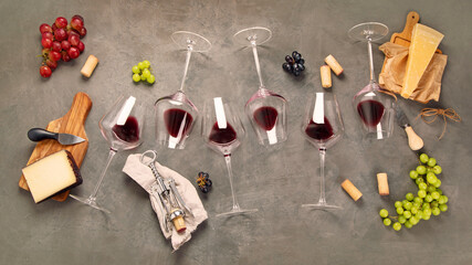 Variety of wine and snack set. Different types of grapes. Fresh ingredients on grey background. Top view
