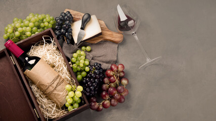 Variety of wine and snack set. Different types of grapes. Fresh ingredients on wooden background.