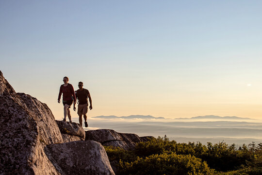 Male and female hiker walk along Appalachian Trail in mountains, Maine