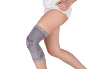 Knee Support Brace on leg isolated on white background. Orthopedic Anatomic Orthosis. Braces for...