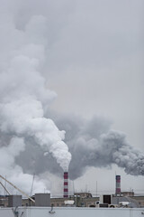 Fototapeta na wymiar industrial chimneys with heavy smoke causing air pollution on the gray smoky sky background