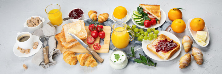 Delicious fresh breakfast served with drinks, croissants and fruits.