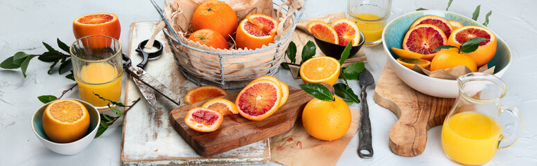 Obraz na płótnie Canvas Oranges and juice in basket on light background