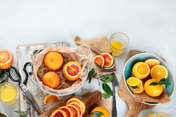 Oranges and juice in basket on light background