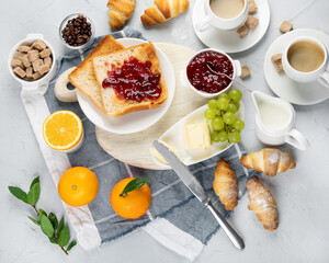 Delicious fresh breakfast served with drinks, croissants and fruits.