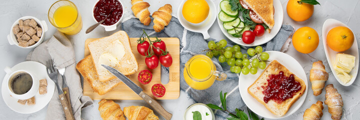 Delicious fresh breakfast served with drinks, croissants and fruits.
