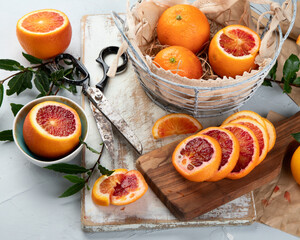 Oranges and juice in basket on light background