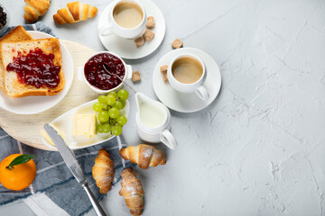 Delicious fresh breakfast served with drinks, croissants and fruits.