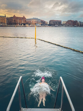 Laughing Winter Bather Making Waves In Still Water Copenhagen, Denmark